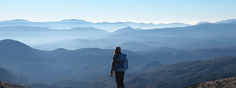 woman looking at mountain ranges