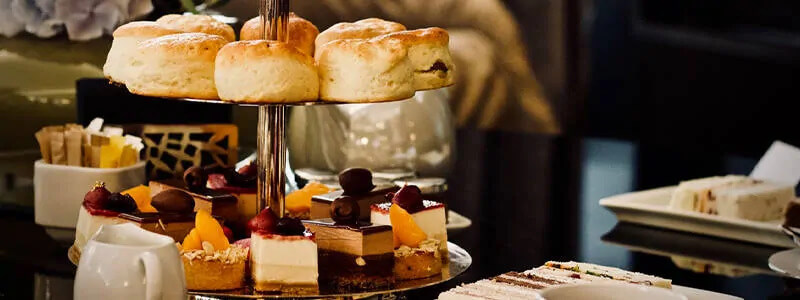 Desserts on a stand next to a table