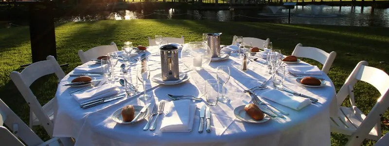 Table with cutlery and plates with bread