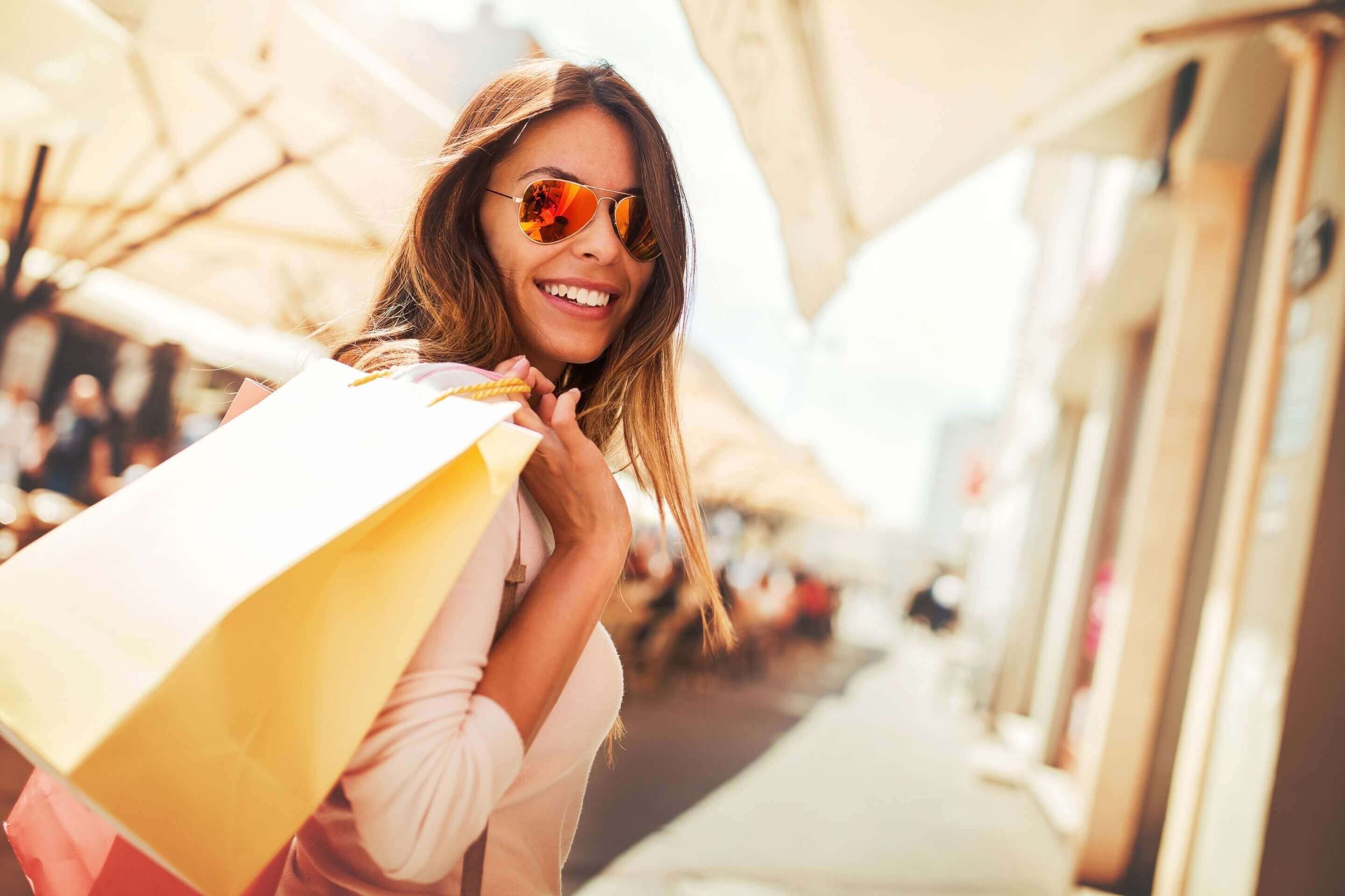 similing woman carrying yellow handbag