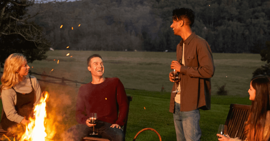 friends laughing by fireplace hawkesbury valley
