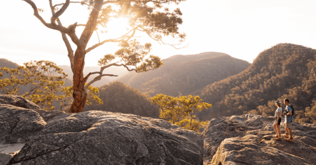 couple hiking overlooking mountains