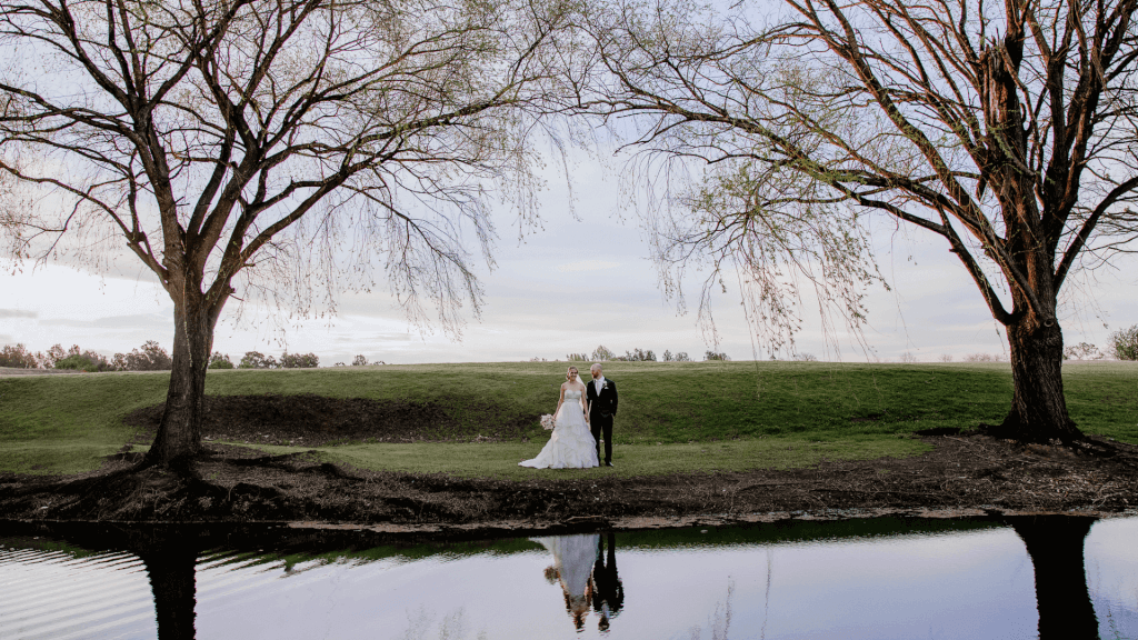 wedding-couple posing-lakeside