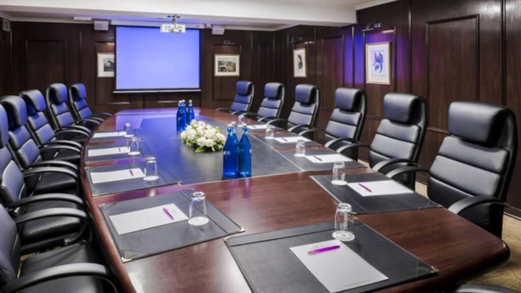 Boardroom With Dark Table with Black Leather Chairs