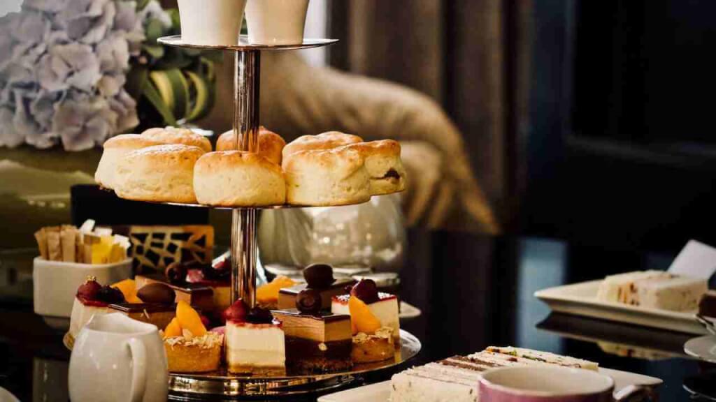 Scones and petit fours on high tea tray