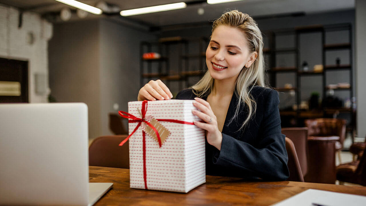 Woman opening Christmas present